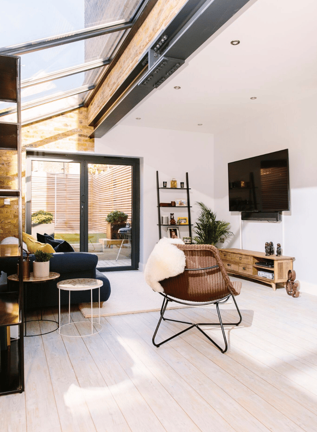 living room interior design with bifold doors and skylights 