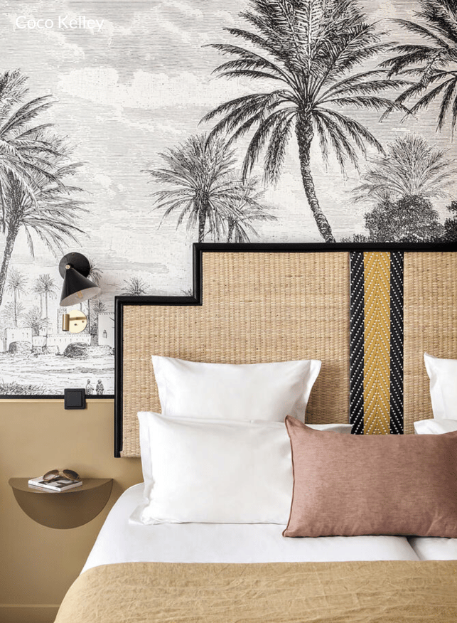 wall mural master bedroom with statement cane rattan headboard and wall lighting 
